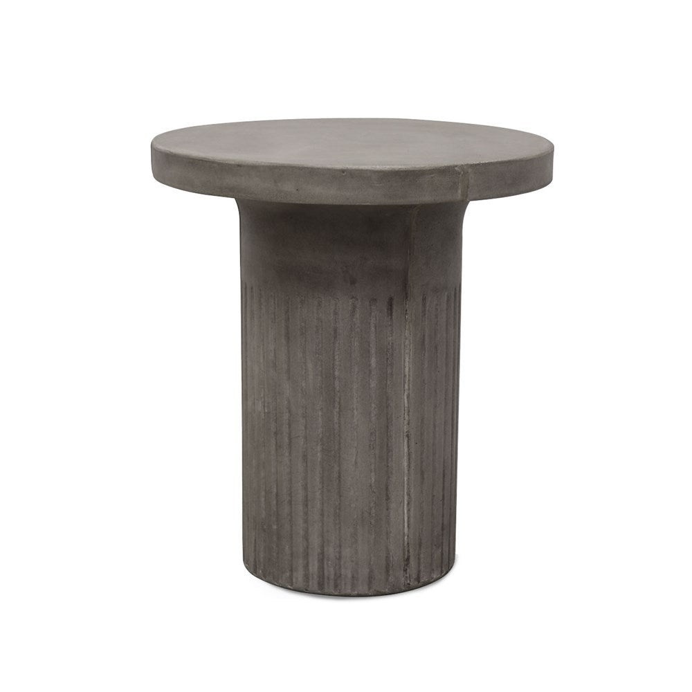 Modern concrete accent table beside lounge or bed