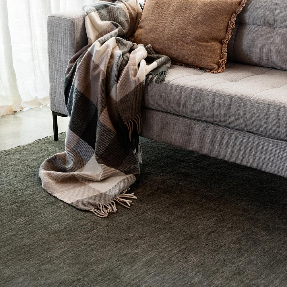 Elegant forest green wool rug styled in modern living space – BLACK Concept Store