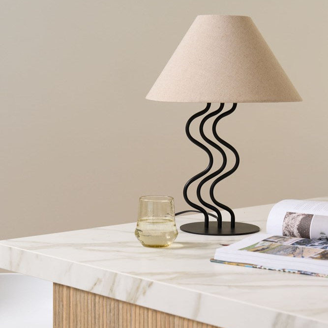 Surge Table Lamp with sculptural ripple-like stem and linen shade