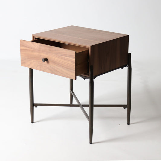 A compact and functional side table in a warm walnut finish, featuring three drawers and a sleek, modern profile.