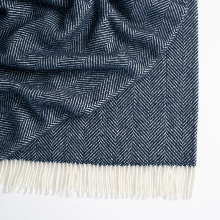 Shop the Magnus wool throw 150x183cm – a thick, 100% New Zealand wool throw with classic herringbone weave and fringe, perfect for cosy living and gifting.