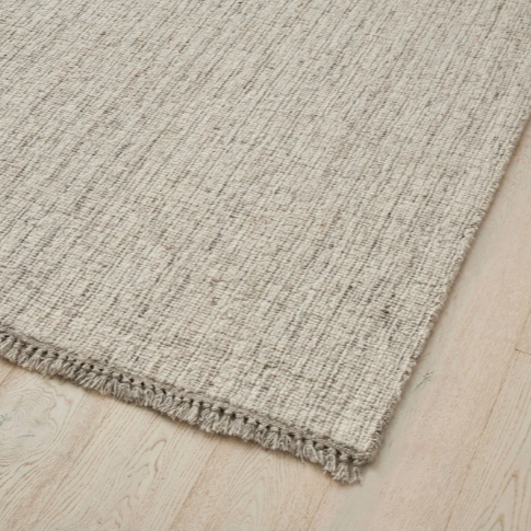 Handwoven multi-tone Puglia rug styled in modern living area – BLACK Concept Store