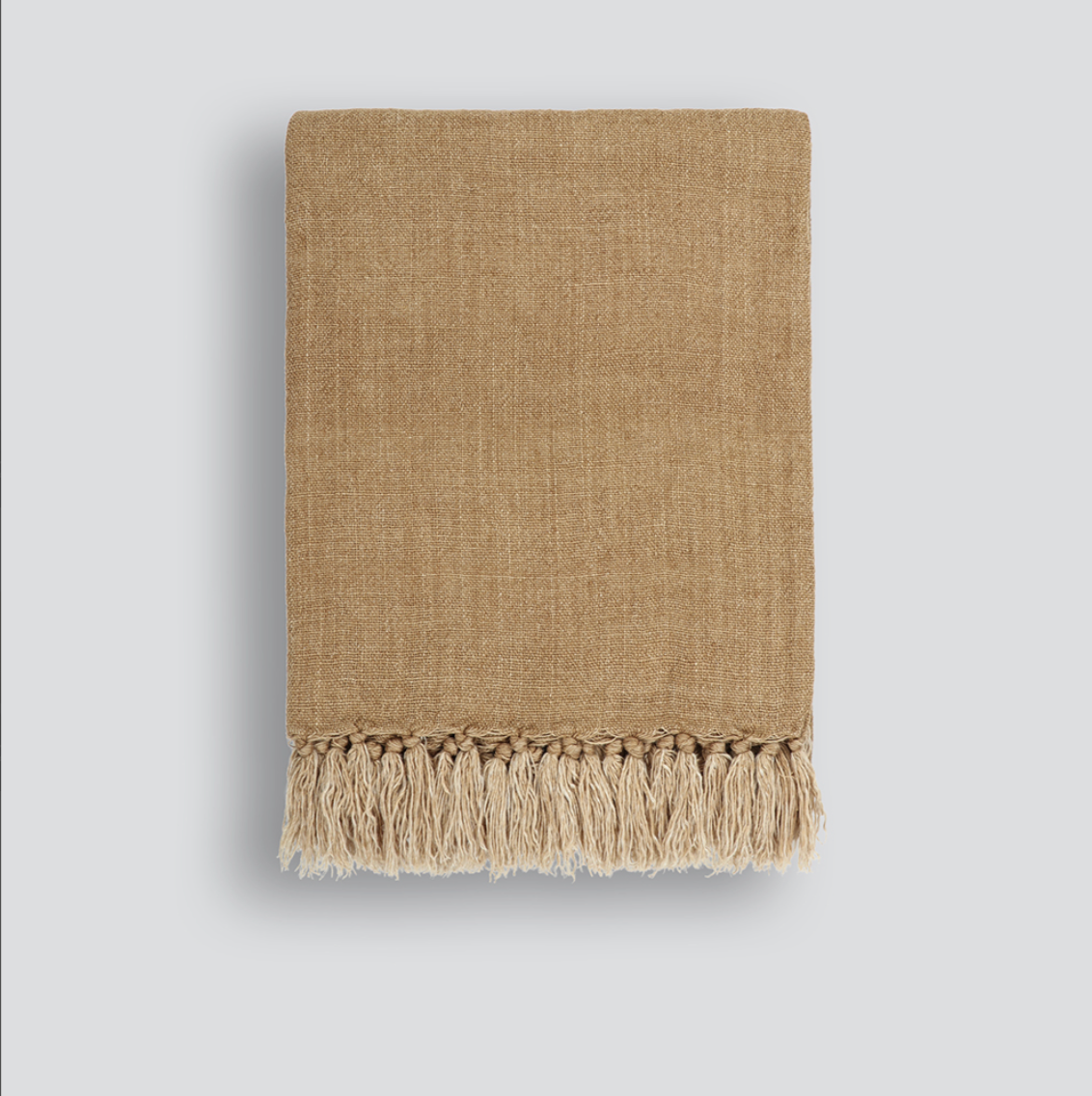 Light, natural-toned linen Millhouse Throw draped over a chair – BLACK Concept Store