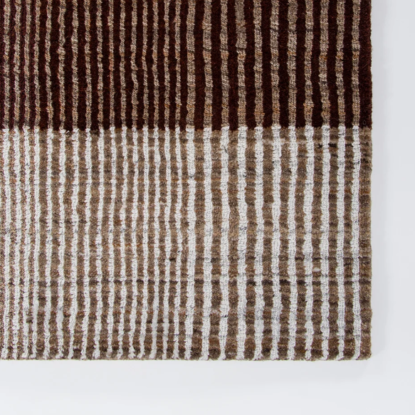 Shop the Baya Bedrock Outdoor Rug at Comber and Comber. A textured recycled PET rug for sheltered outdoor living. Available in Sand, Claret and Zinc.