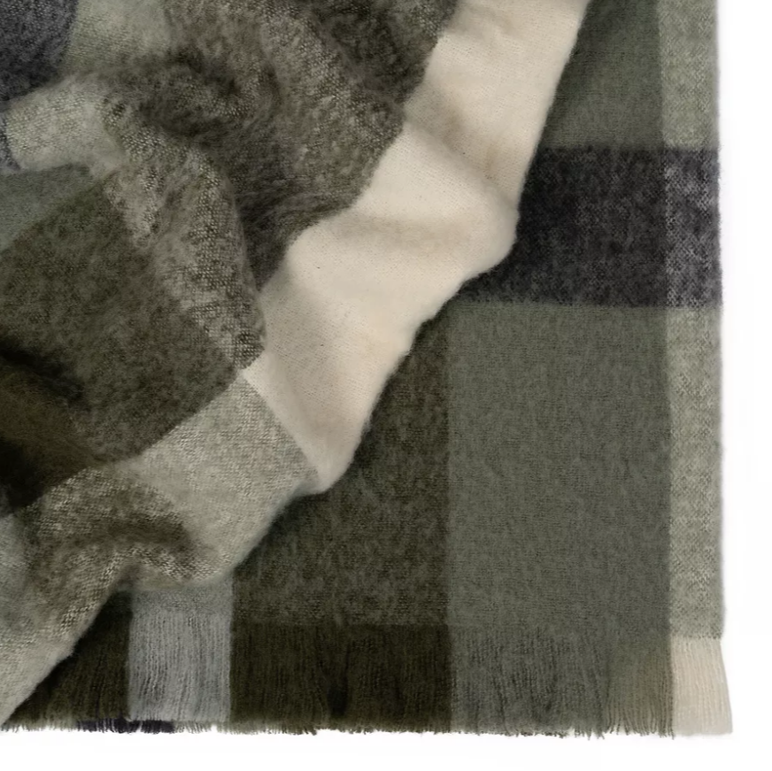 Soft, plush Kinloch throw draped over a living room sofa