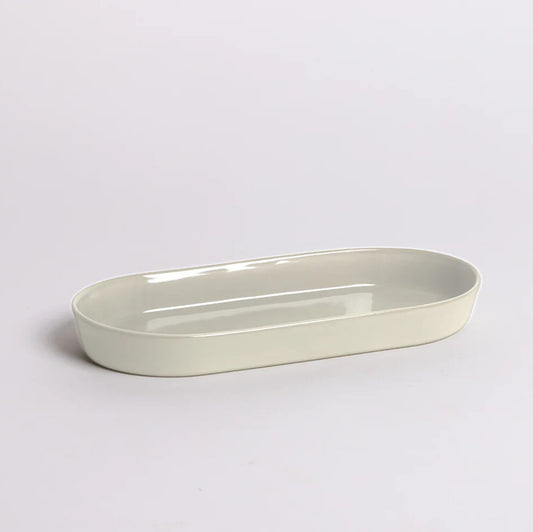 Smooth seamless Noosa Dish styled on a vanity or countertop