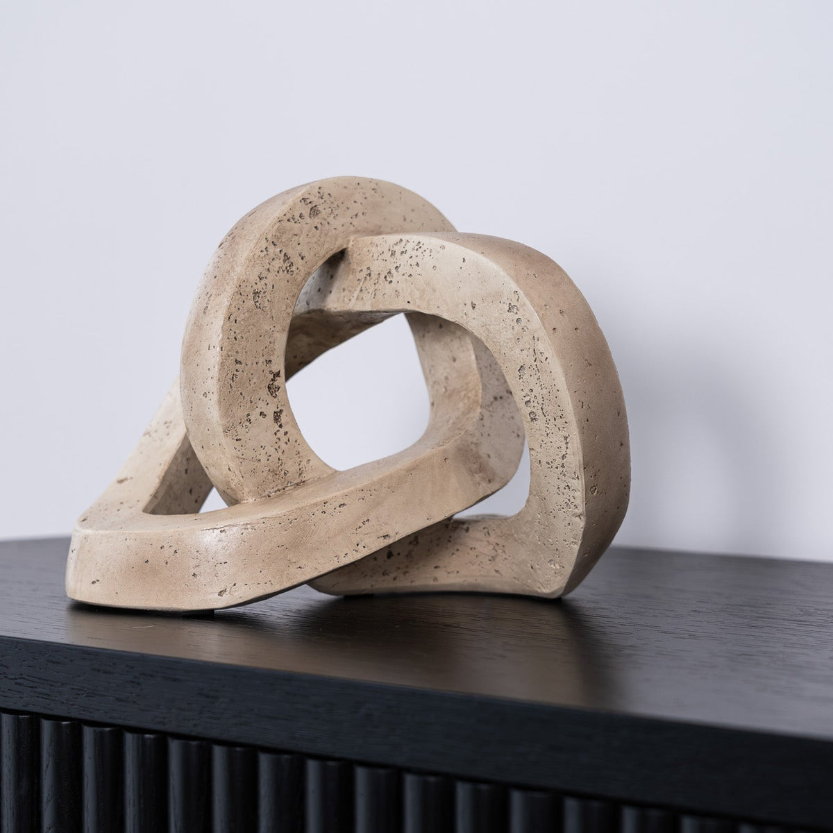 The Marley Decorative Link in resin features an interlocking sculptural design, perfect for adding modern style and texture to tables, shelves, or layered displays.