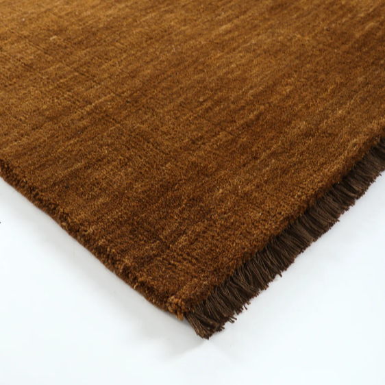 Handknotted pecan brown wool rug styled in modern living room – BLACK Concept Store