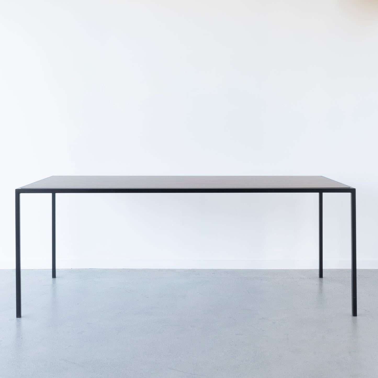 Nero dining table with versatile reversible top design