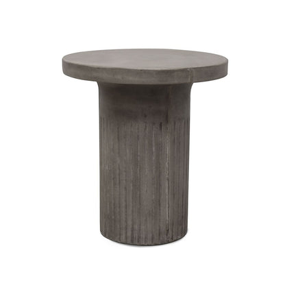 Modern concrete accent table beside lounge or bed