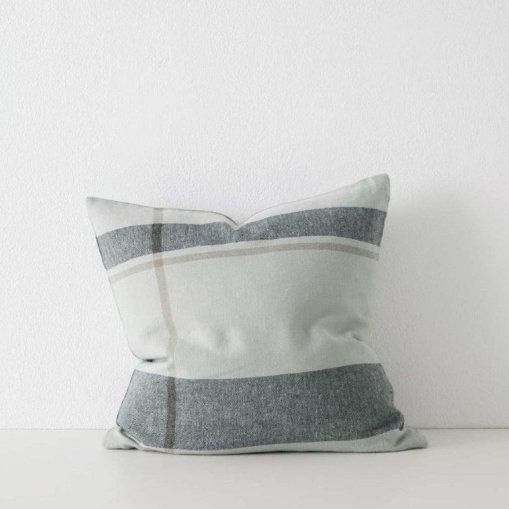 Feather-filled Dante Cushion styled on a neutral sofa