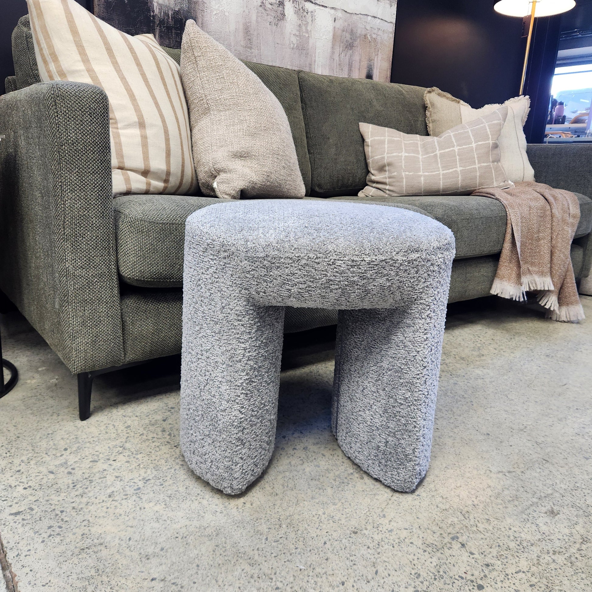 Grey boucle upholstered stool for living or bedroom spaces