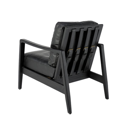 The Reid Armchair blends contemporary design with premium comfort, featuring hand-dyed leather, a sculptural strap backrest with brass buckle detail, and a supportive foam and feather cushion combination.