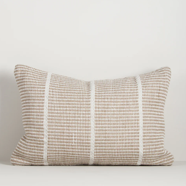 Shop the Baya Shore Outdoor Cushion at Comber and Comber. A handwoven recycled PET lumbar cushion with a timeless linear design, available in multiple colours.