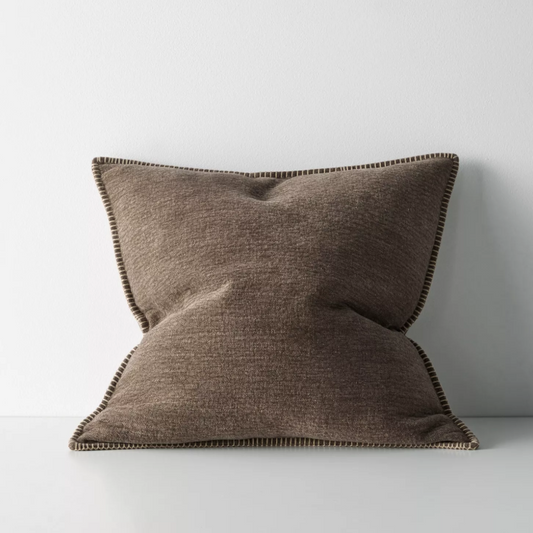 The Alba 50x50cm cushion features a soft linen-poly blend with a subtle two-tone weave and blanket stitch edging, offering relaxed texture and timeless versatility.