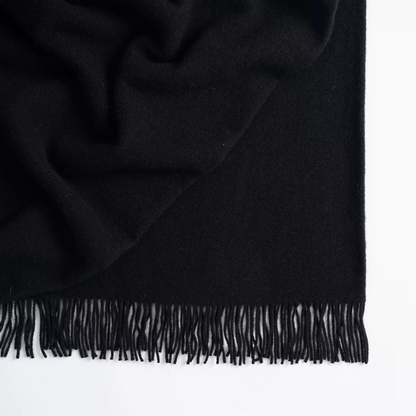 Shop the Nevis lambswool throw 130x200cm – made from 100% New Zealand wool with a soft, thick texture and tassel fringe, perfect for cosy living and gifting.