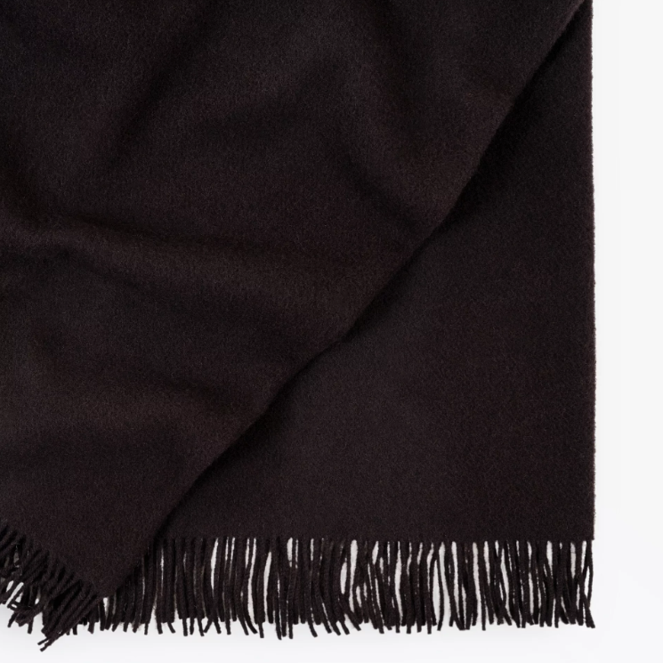 Shop the Nevis lambswool throw 130x200cm – made from 100% New Zealand wool with a soft, thick texture and tassel fringe, perfect for cosy living and gifting.