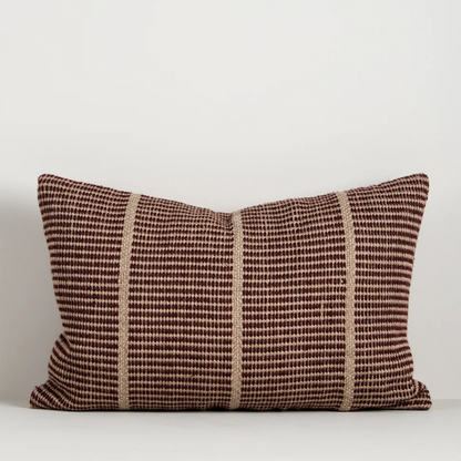 Shop the Baya Shore Outdoor Cushion at Comber and Comber. A handwoven recycled PET lumbar cushion with a timeless linear design, available in multiple colours.
