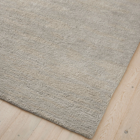 Handcrafted 100% wool Valencia rug styled in lounge area – BLACK Concept Store