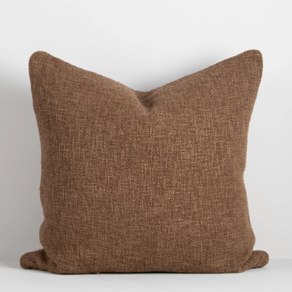 Shop the Cyprian cushion – handwoven from cotton, linen, and viscose with a chunky artisan texture, perfect for layering or statement styling.