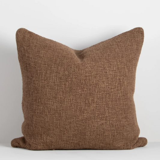Shop the Cyprian cushion – handwoven from cotton, linen, and viscose with a chunky artisan texture, perfect for layering or statement styling.