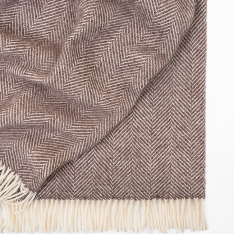 Shop the Magnus wool throw 150x183cm – a thick, 100% New Zealand wool throw with classic herringbone weave and fringe, perfect for cosy living and gifting.