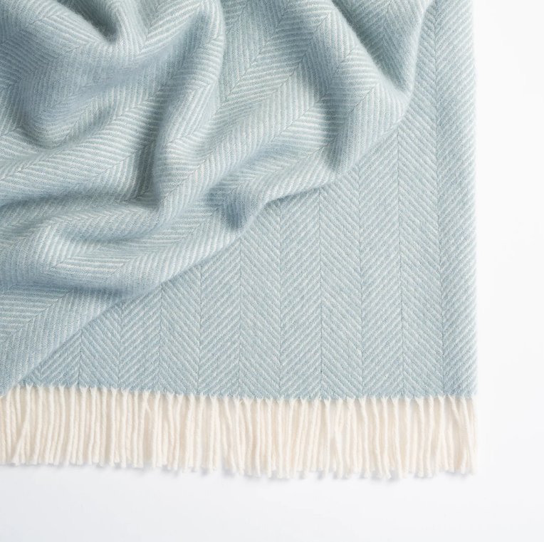 Shop the Magnus wool throw 150x183cm – a thick, 100% New Zealand wool throw with classic herringbone weave and fringe, perfect for cosy living and gifting.