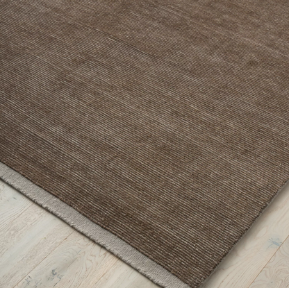 Discover the Remo Rug — 100% New Zealand wool with a high loop horizontal stripe design, cut border, and cotton backing. Available in 4 colours, ideal for contemporary living.