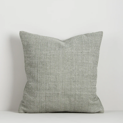 Shop the Baya Dune Outdoor Cushion at Comber and Comber. Handwoven from recycled PET with a textured two-tone design, perfect for stylish outdoor living.