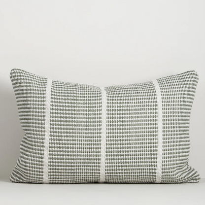 Shop the Baya Shore Outdoor Cushion at Comber and Comber. A handwoven recycled PET lumbar cushion with a timeless linear design, available in multiple colours.