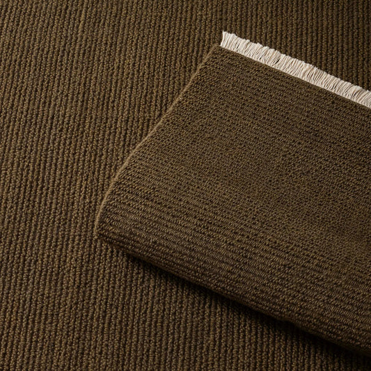 moss green rug with a textured pattern and fringe on a wooden floor. 2x3 3x4. 100% NZ wool