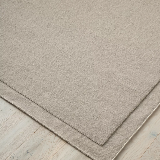 Shop the Cassio Rug — 100% New Zealand wool loop pile with textured finish, serged edge, and durable cotton backing. Available in 4 colours and 2 sizes, perfect for modern living.