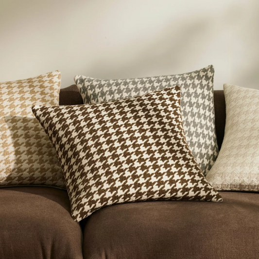 Shop the Giovanni 50x50cm cushion – a bouclé houndstooth design with geometric texture, perfect for layering or as a luxurious statement accent.