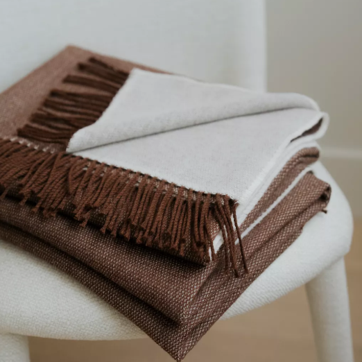 Shop the Harris Merino lambswool throw 145x200cm – reversible, lightweight, and soft with refined texture, perfect for year-round comfort and gifting.