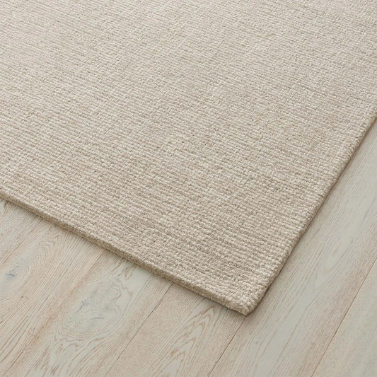 Beige rug on a wooden floor. 2x3. 100 NZ Wool
