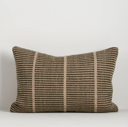 Shop the Baya Shore Outdoor Cushion at Comber and Comber. A handwoven recycled PET lumbar cushion with a timeless linear design, available in multiple colours.