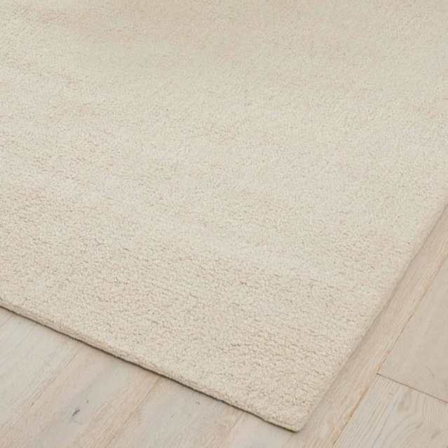 Vista cushion in textured bouclé with Sunset clay tones