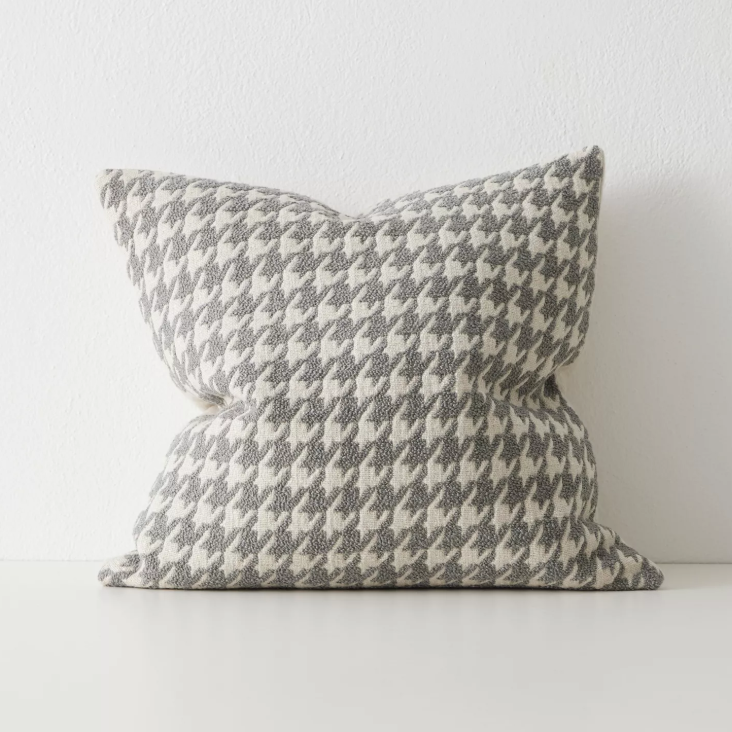 Shop the Giovanni 50x50cm cushion – a bouclé houndstooth design with geometric texture, perfect for layering or as a luxurious statement accent.