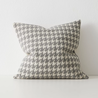 Shop the Giovanni 50x50cm cushion – a bouclé houndstooth design with geometric texture, perfect for layering or as a luxurious statement accent.