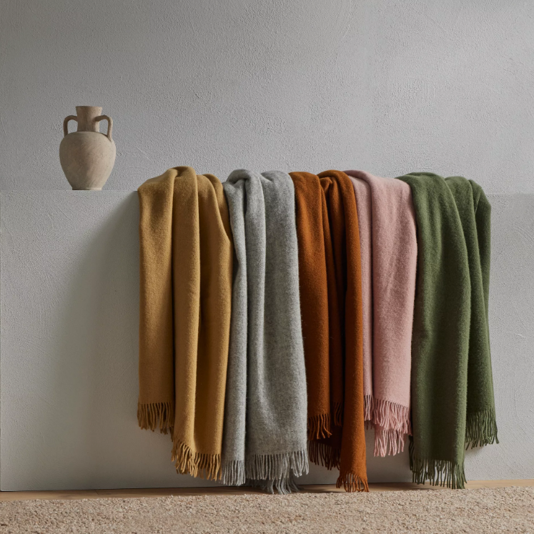 Shop the Nevis lambswool throw 130x200cm – made from 100% New Zealand wool with a soft, thick texture and tassel fringe, perfect for cosy living and gifting.