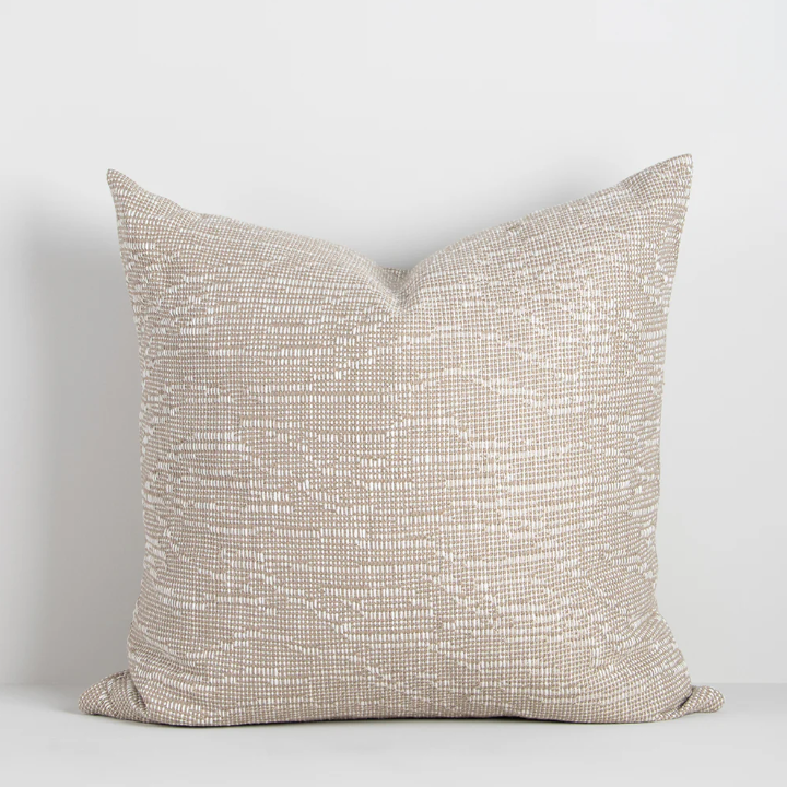 The Adler 55x55cm cushion features a subtle flecked weave in warm tones, adding refined texture and versatility to your interior styling.