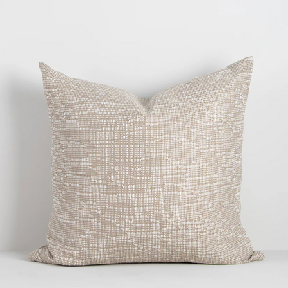 The Adler 55x55cm cushion features a subtle flecked weave in warm tones, adding refined texture and versatility to your interior styling.