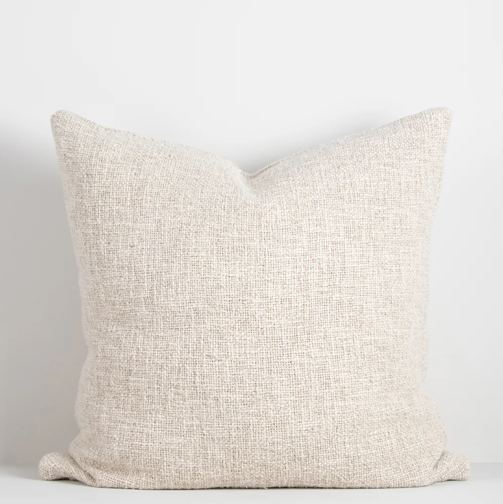 Shop the Cyprian cushion – handwoven from cotton, linen, and viscose with a chunky artisan texture, perfect for layering or statement styling.