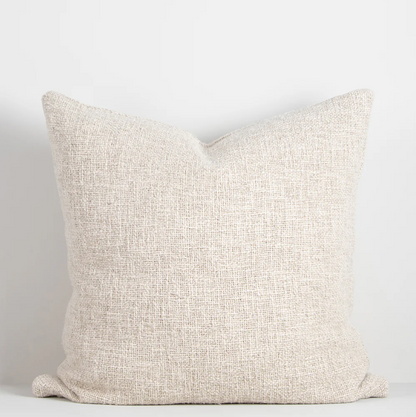Shop the Cyprian cushion – handwoven from cotton, linen, and viscose with a chunky artisan texture, perfect for layering or statement styling.