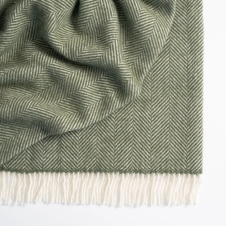 Shop the Magnus wool throw 150x183cm – a thick, 100% New Zealand wool throw with classic herringbone weave and fringe, perfect for cosy living and gifting.