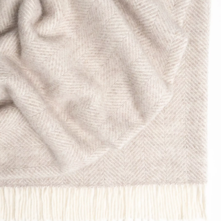 Shop the Magnus wool throw 150x183cm – a thick, 100% New Zealand wool throw with classic herringbone weave and fringe, perfect for cosy living and gifting.