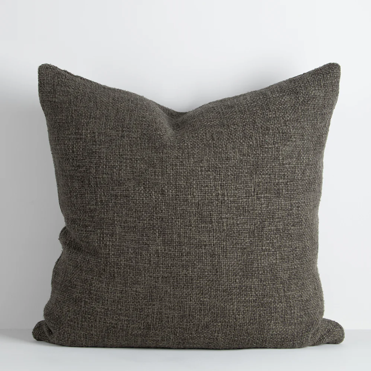 Shop the Cyprian cushion – handwoven from cotton, linen, and viscose with a chunky artisan texture, perfect for layering or statement styling.