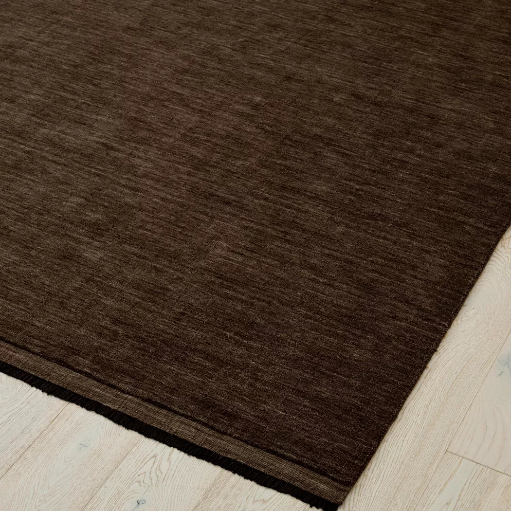 Earthy brown rug on a light wood floor. 2x3m 3x4m. 100% NZ wool