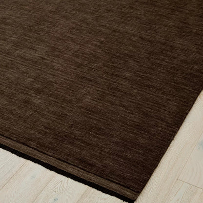 Earthy brown rug on a light wood floor. 2x3m 3x4m. 100% NZ wool