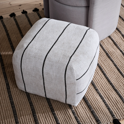 Moroccan-inspired Sigrid Pouf used as footrest or seating
